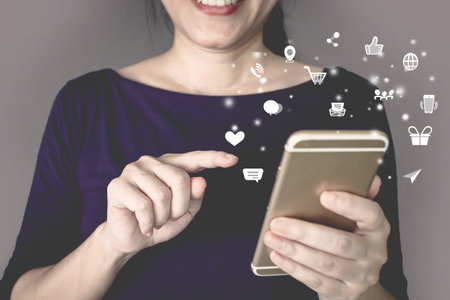 Woman is press touch screen on smartphone with modern technology digital icon. Shopping online. a Social networking.の写真素材