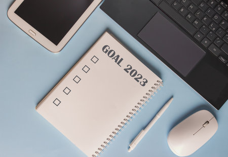 Laptop, pen and notebook are on desk with Goals word in Year 2023の写真素材