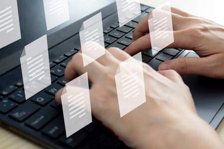 Woman holds pen and writing to send electronic document or take note and another hand using laptop. A Business and Marketing strategy and concept.の写真素材