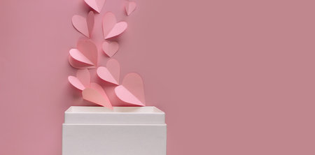 Pink paper heart shape are blow out of white box for celebrate on a Valentine's day to present love.の写真素材