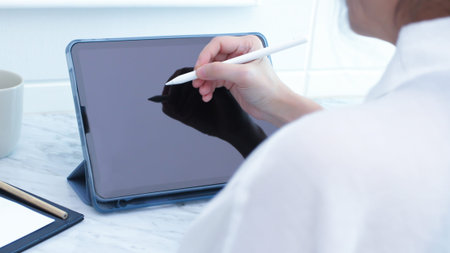 Back view of woman using digital tablet for working  to search on web page, technology, website,...