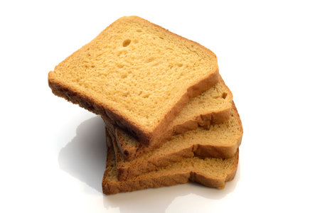 Whole wheat brown bread neatly stacked on white background