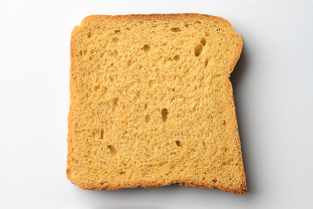 Slice of a whole wheat brown bread on white background