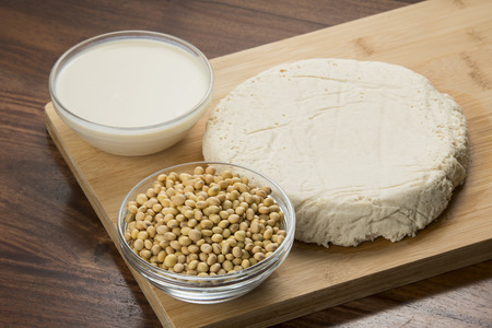 Food : Bowls of Soy Milk,Soybeans And Tofu Isolated on Wooden Backgroundの写真素材