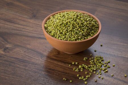 Fresh Green Tender Sorghum in a Earthen Bowl on Woodenの写真素材