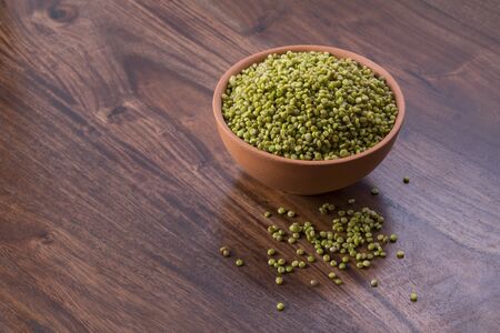 Fresh Green Tender Sorghum in a Earthen Bowl on Woodenの写真素材