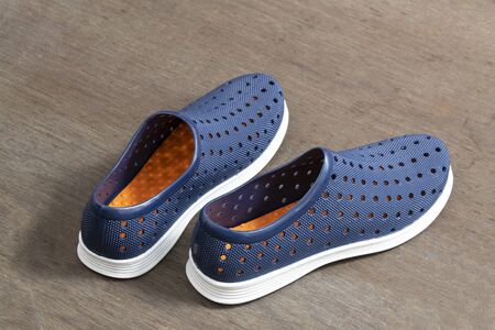 Pair of Blue Shoes Isolated on Wooden Backgroundの写真素材