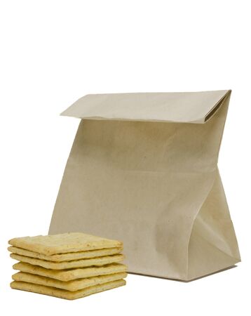 Stack of crackers and brown paper bag ,on white backgroundの写真素材