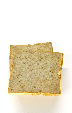 wheat loaf bread sliced, on whiteの写真素材