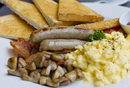 American breakfast with scrambled eggs and sausagesの写真素材