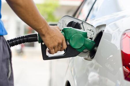 Refueling Car With Gasoline Pump Nozzle, Selective Focus on pump nozzleの写真素材