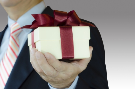 business man holding gift box ,concept for celebration , isolated on white backgroundの写真素材
