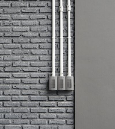 Three Electrical switch on old gray wallの写真素材