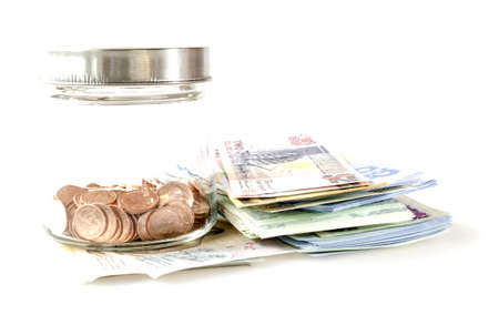 Banknote and coins in the bottle, isolate on white backgroundの写真素材