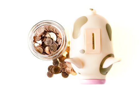 Piggybank and coins ,isolated on white backgroundの写真素材