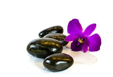 spa with hot stone massage and purple orchidの写真素材