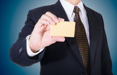 Businessman showing his credit card, isolated background objectの写真素材