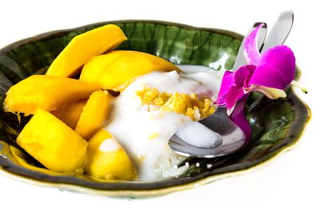 Thai style dessert, Mango with sticky rice ,Decorated with purple orchidの写真素材