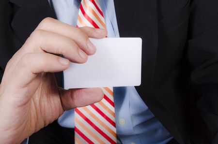 Business man handing a blank business cardの写真素材