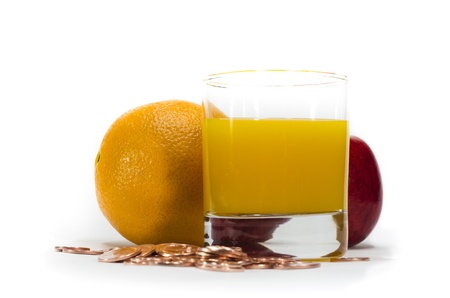 Orange juice and coins ,Concept for healthy and moneyの写真素材