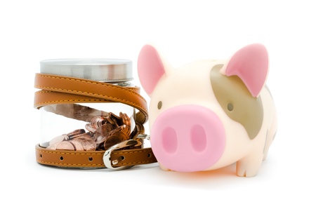 piggy bank and coins in the bottle with belt, concept for saving moneyの写真素材