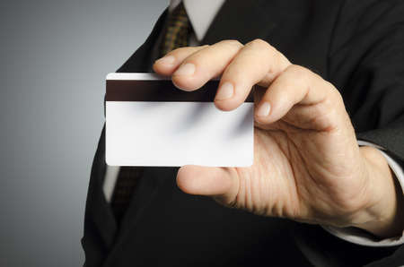 Business man showing a blank card,isolated backgroundの写真素材
