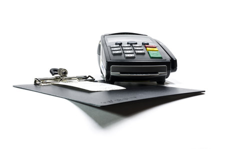 Sale slip on clipboard and credit card reader,isolated on white background