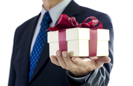 Business man holding a gift box on white backgroundの写真素材