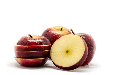 Red and sliced apples , isolated on white backgroundの写真素材