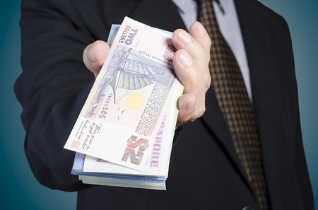 businessman showing packs of international bank noteの写真素材