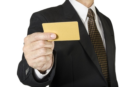 Businessman with credit card in hand isolated on white backgroundの写真素材