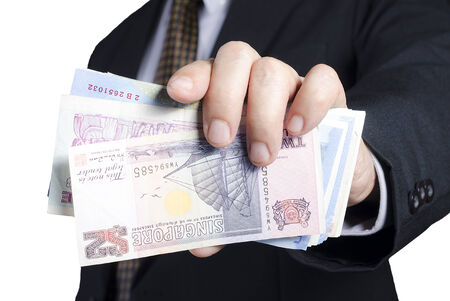businessman showing packs of international bank noteの写真素材