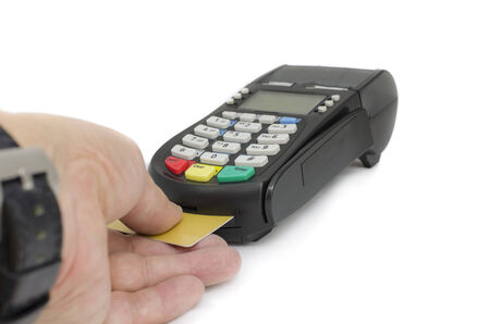 Close up of businessman hand insert credit card in credit card reader machineの写真素材