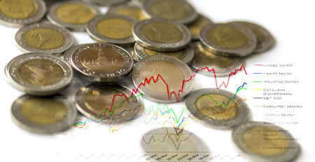 Coins isolated on white background with graph on background : Concept for investmentの写真素材