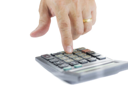 Close up of finger pressing calculator button , Isolated on white background : business and office conceptの写真素材