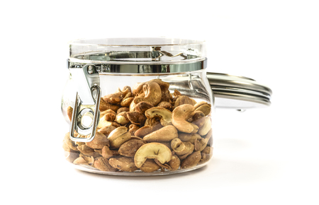 Almond nuts and  cashew nuts in glass pot isolated on white backgroundの写真素材