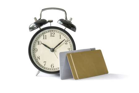 Alarm clock and credit card, isolated on white background : concepts and ideasの写真素材