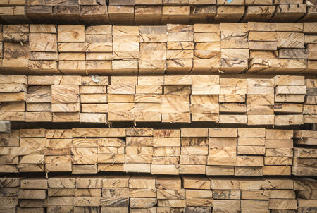 Background of Stacked Wood Cut in Squared Timberの写真素材