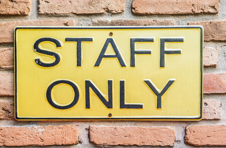 Staff only sign on brick wallの写真素材