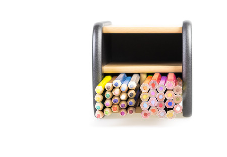 stacked color pencils in a box , isolated on white backgroundの写真素材