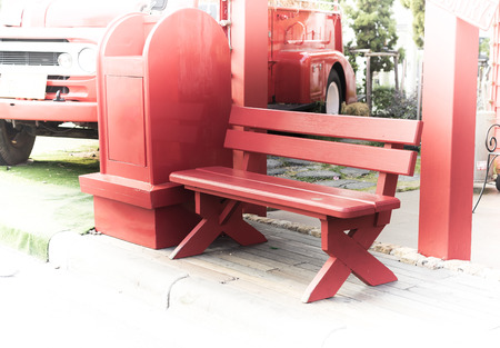 red old style wood seat at bus stationの写真素材