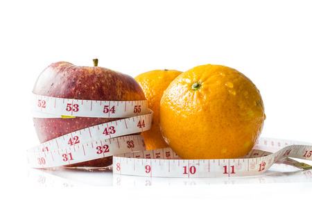 Apple and orange with  measurement tape , Isolated on white backgroundの写真素材