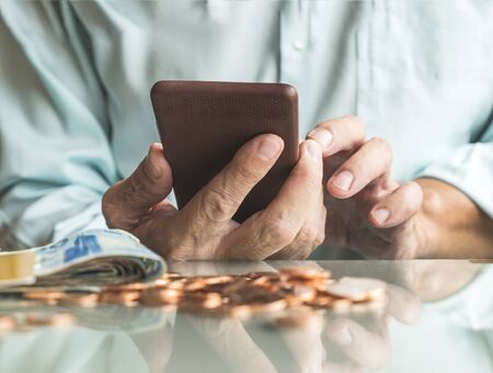 Businessman using smartphone on cashier desk : Concept for business and Moneyの写真素材