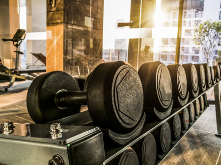 Rack of dumbbell in fitness room at the morningの写真素材