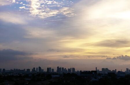 Beautiful sunset in the city with silhouette background of buildingの写真素材
