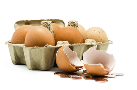 Broken egg with coins inside , Concept for healthy and moneyの写真素材