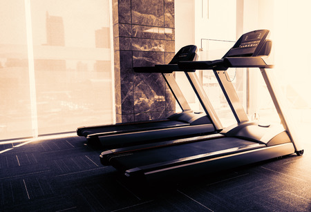 Empty treadmill in fitness room at the morningの写真素材
