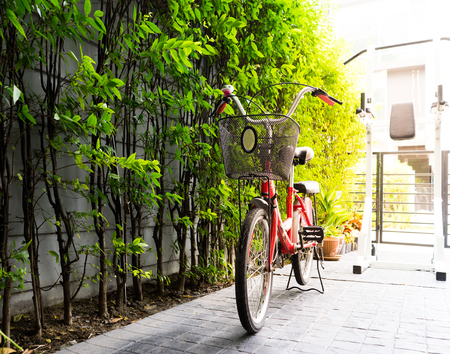 Retro bicycle with basket parking near house wallの写真素材