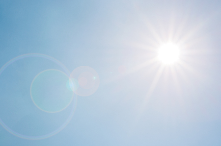 Beautiful shining sun over clear sky with sun rays effect.の写真素材