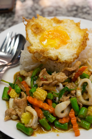 Rice topped with egg and stir-fried pork and basil : Famous Thai street foodの写真素材